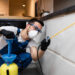 Male Worker Spraying Pesticide On Cabinet